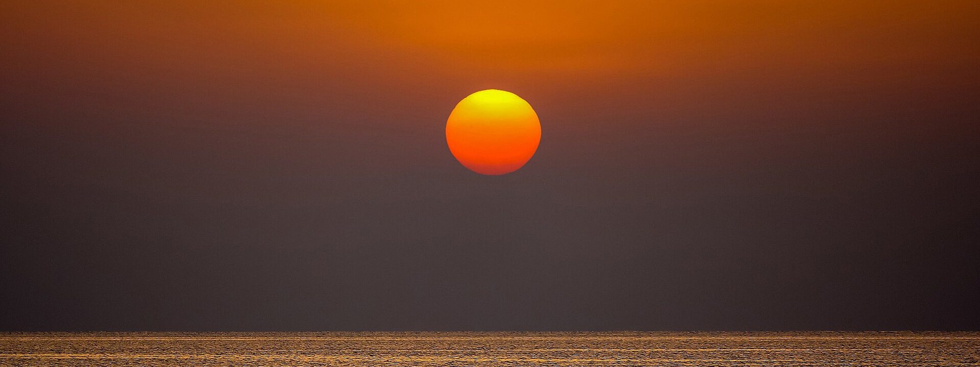 Golden sun low over the Red Sea