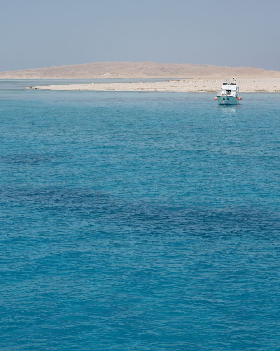 Boat on turquoise water near Paradise Island, Hurghada, Red Sea
